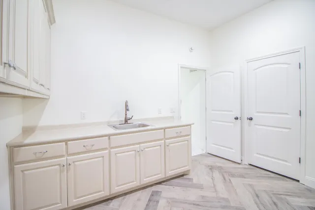 a bathroom with a tub a sink and a mirror