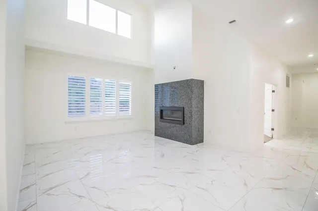 a view of a kitchen with a sink and a fireplace