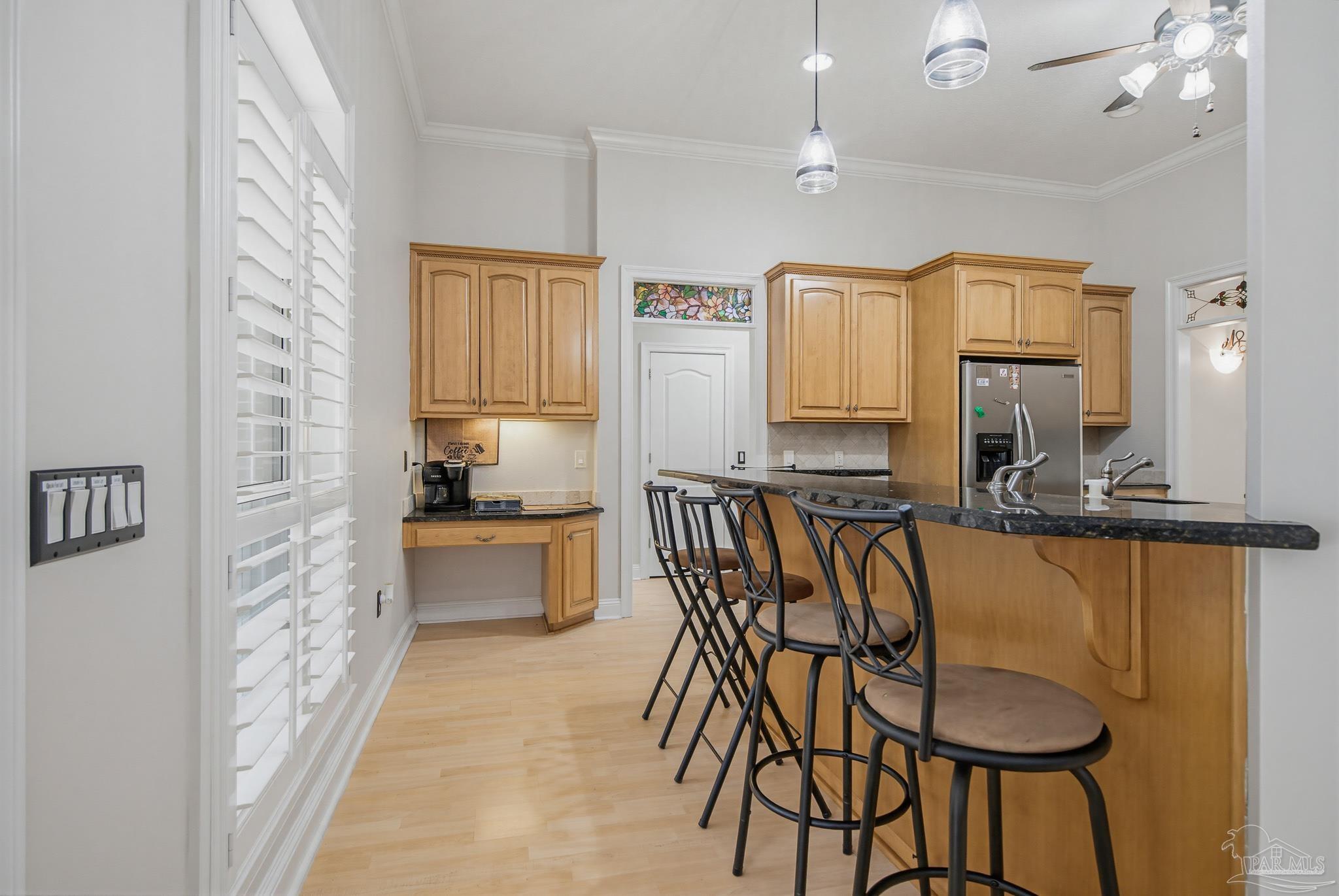 2855 Walling Road Milton, FL 32570 - Photo 18 of 55 a kitchen with a table chairs refrigerator and cabinets