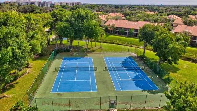 an aerial view of a tennis ground and a large pool
