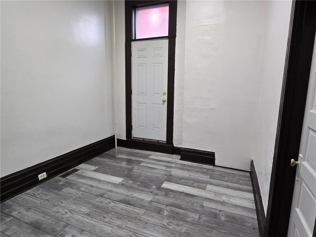 812 McClure Street, Unit 812 Homestead, PA 15120 - Photo 5 of 10 a view of an empty room and wooden floor