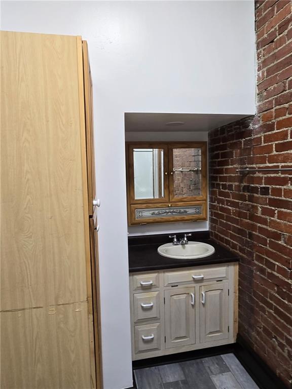 812 McClure Street, Unit 812 Homestead, PA 15120 - Photo 6 of 10 a bathroom with a granite countertop sink and a mirror