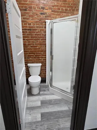 a bathroom with a toilet and a shower