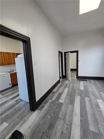 a view of hallway with wooden floor