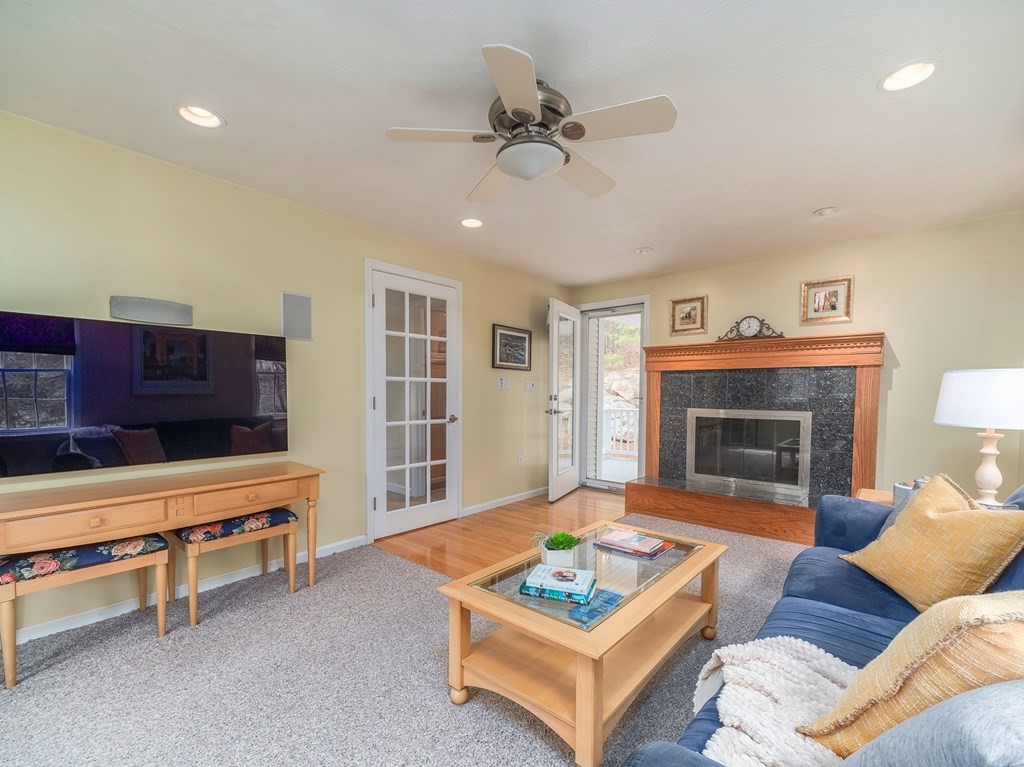 59 Rattlesnake Hill Road Andover, MA 01810 - Photo 18 of 39 a living room with furniture and a fireplace