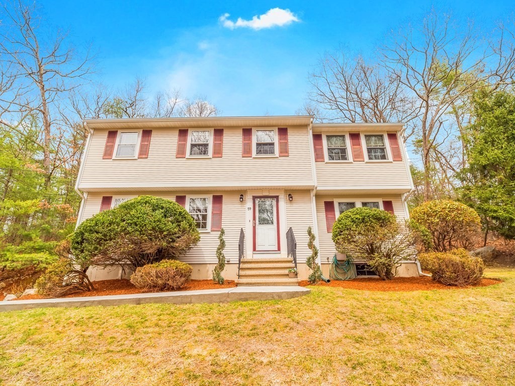 59 Rattlesnake Hill Road Andover, MA 01810 - Photo 2 of 39 a front view of a house with a yard and potted plants
