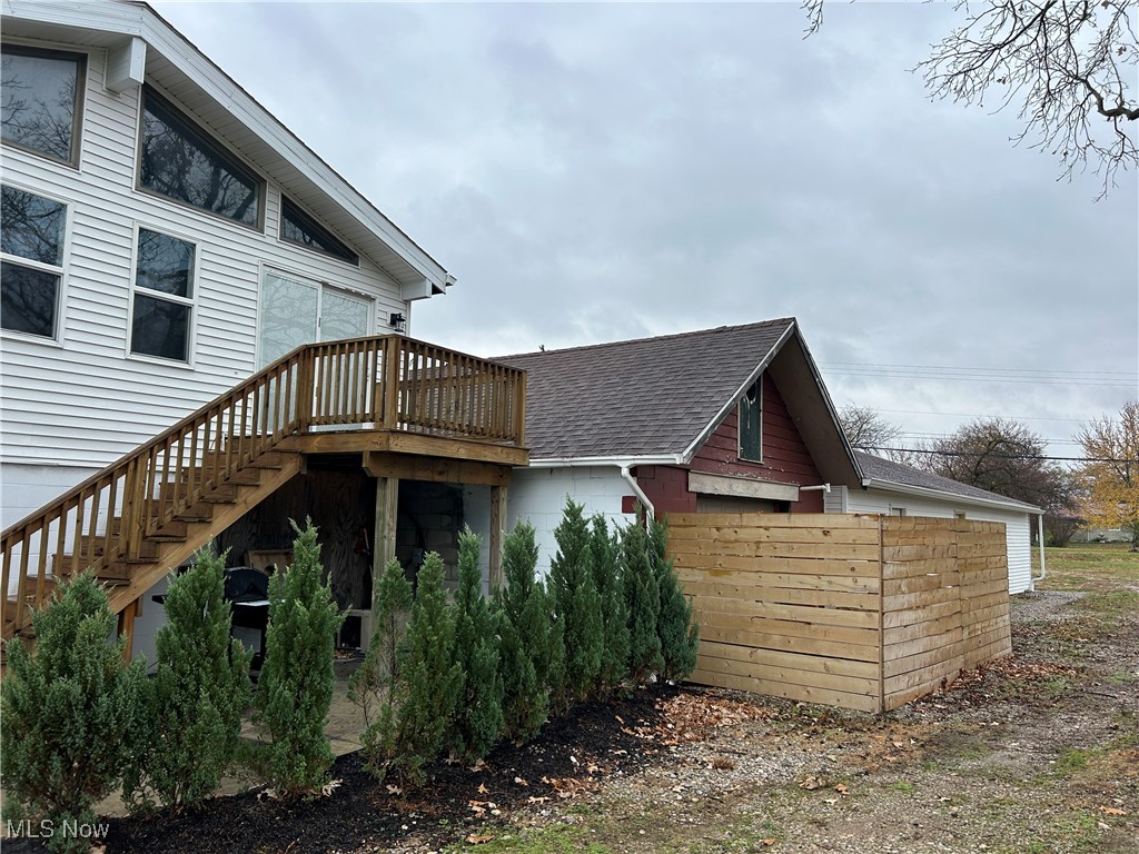 3005 Bardshar Road Sandusky, OH 44870 - Photo 6 of 24 View of side of home featuring a wooden deck, stairs, and a shingled roof