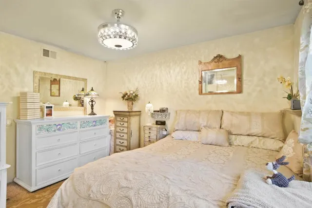 a bedroom with a bed and a chandelier