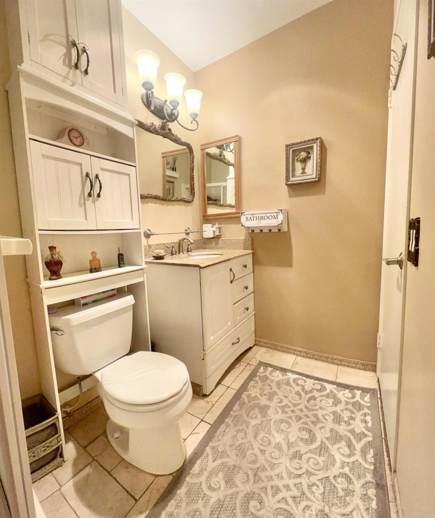 10158 Carefree Drive Santee, CA 92071 - Photo 23 of 38 a bathroom with a toilet sink and mirror