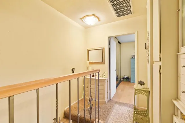 a view of a hallway with a livingroom and a bathroom