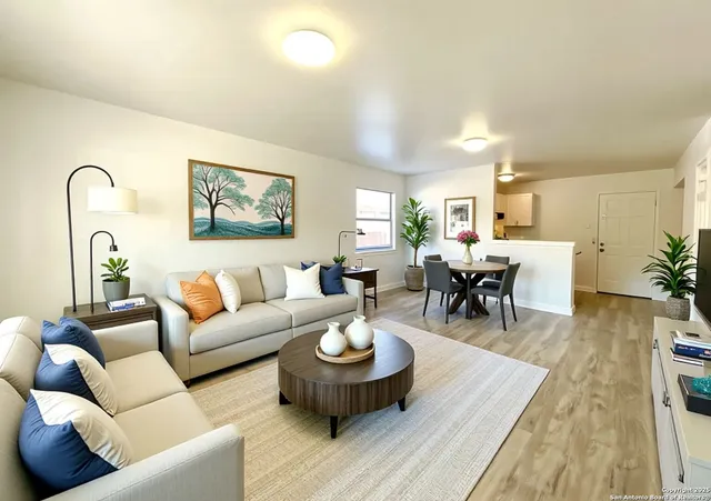 a living room with furniture and wooden floor