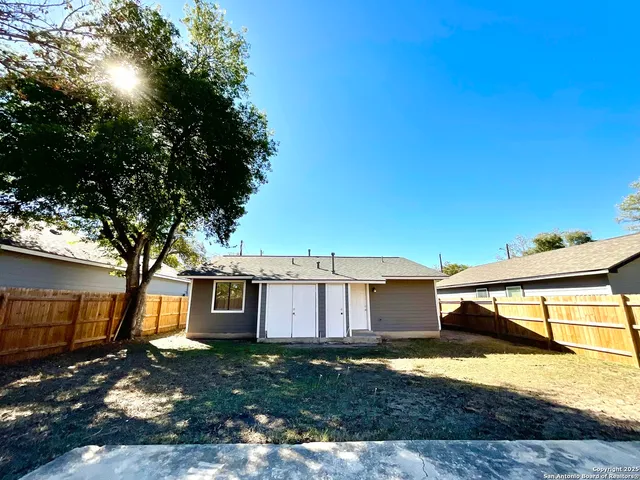 a view of a house with a yard and garage