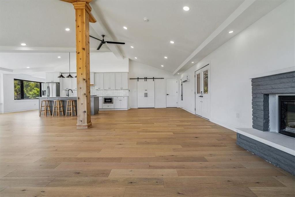 4401 Battle Ridge Road Oakdale, PA 15071 - Photo 11 of 50 a view of an empty room and kitchen with fireplace wooden floor