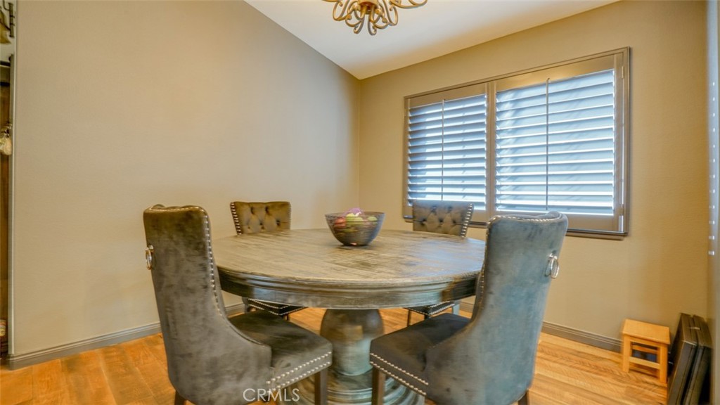 11327 Old Ranch Circle Chatsworth, CA 91311 - Photo 12 of 63 a view of a dining room with furniture and wooden floor