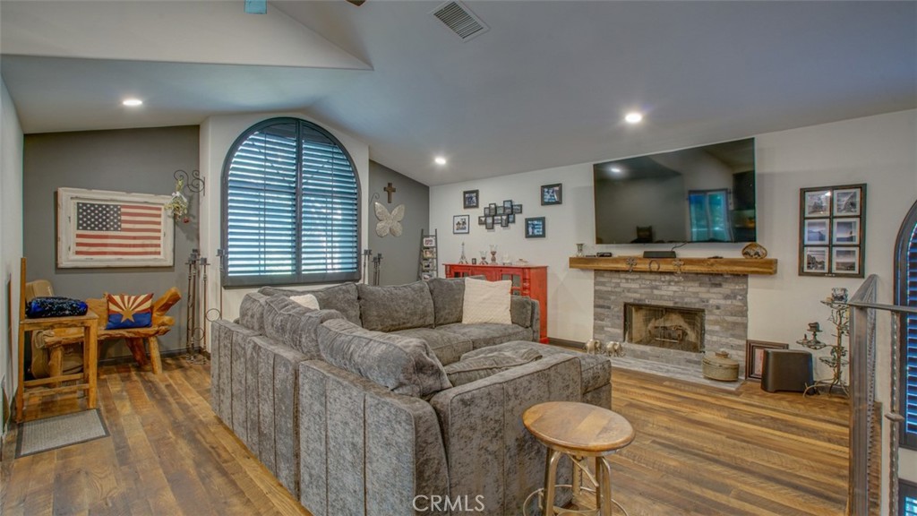 11327 Old Ranch Circle Chatsworth, CA 91311 - Photo 14 of 63 a living room with furniture a fireplace and a flat screen tv