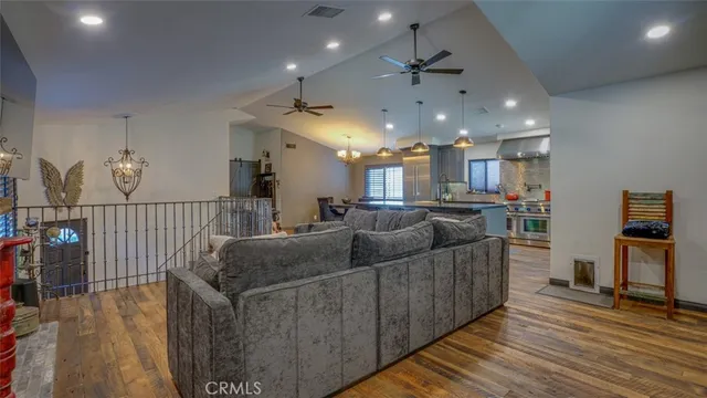 a kitchen filled counter top space a sink a stove and a wooden floor