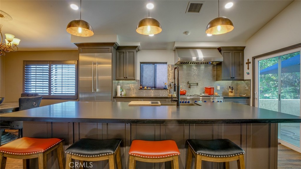 11327 Old Ranch Circle Chatsworth, CA 91311 - Photo 19 of 63 a kitchen with stainless steel appliances granite countertop a stove a sink and a microwave