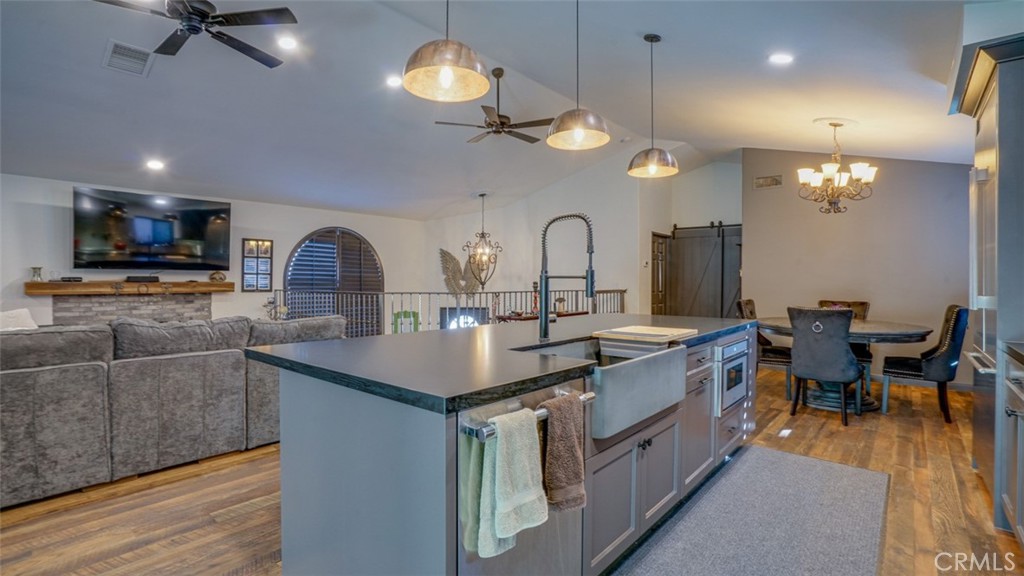 11327 Old Ranch Circle Chatsworth, CA 91311 - Photo 22 of 63 a kitchen with stainless steel appliances a stove center island a dining table and chairs