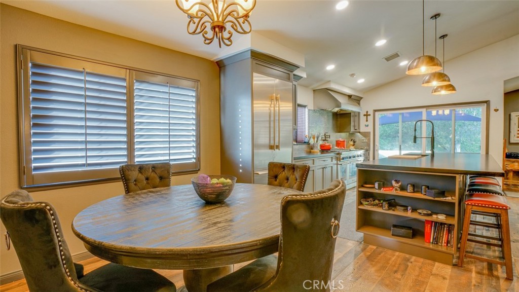 11327 Old Ranch Circle Chatsworth, CA 91311 - Photo 26 of 63 a dining room with furniture and a floor to ceiling window