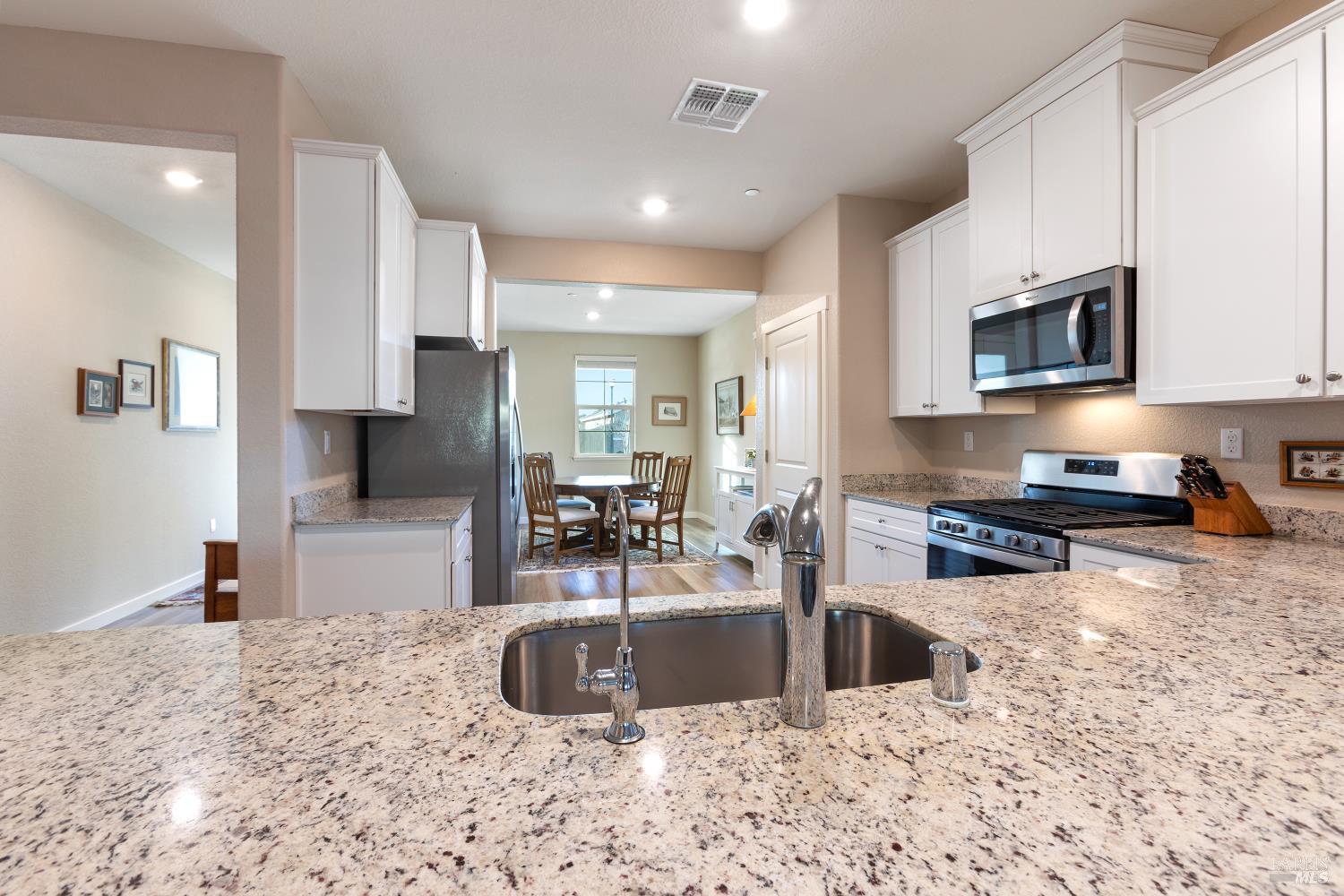 2080 Revival Lane Rio Vista, CA 94571 - Photo 19 of 40 a kitchen with stainless steel appliances a sink a stove a microwave a sink a refrigerator and cabinets