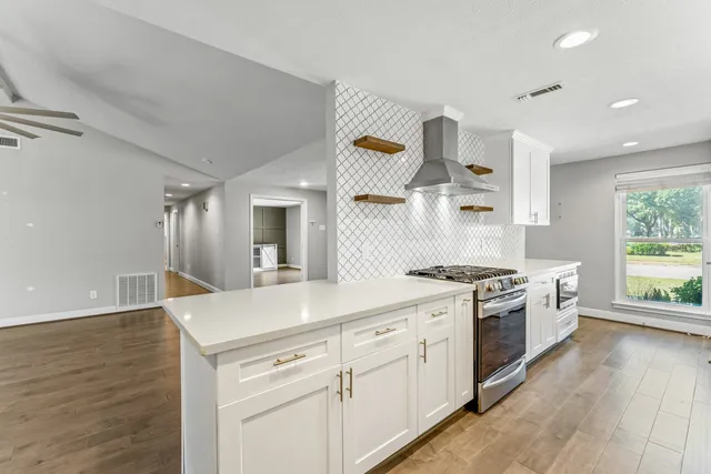 a kitchen with granite countertop white cabinets and white appliances