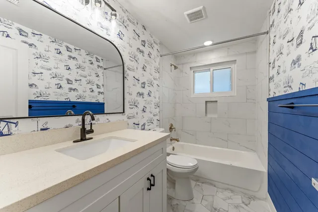 a bathroom with a sink toilet and shower