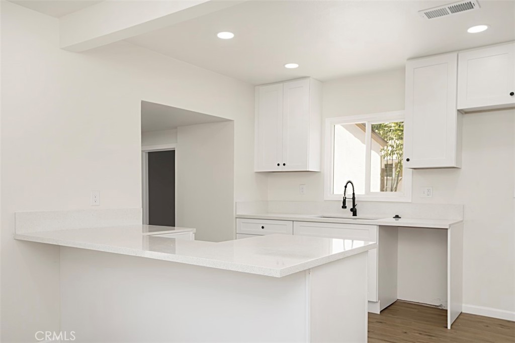 6056 Colonial Drive Riverside, CA 92506 - Photo 12 of 30 a kitchen with a sink cabinets and window