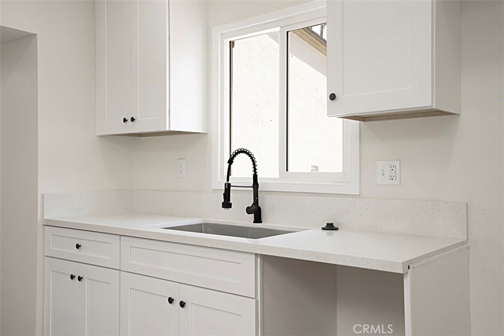 6056 Colonial Drive Riverside, CA 92506 - Photo 14 of 30 a kitchen with a sink and cabinets