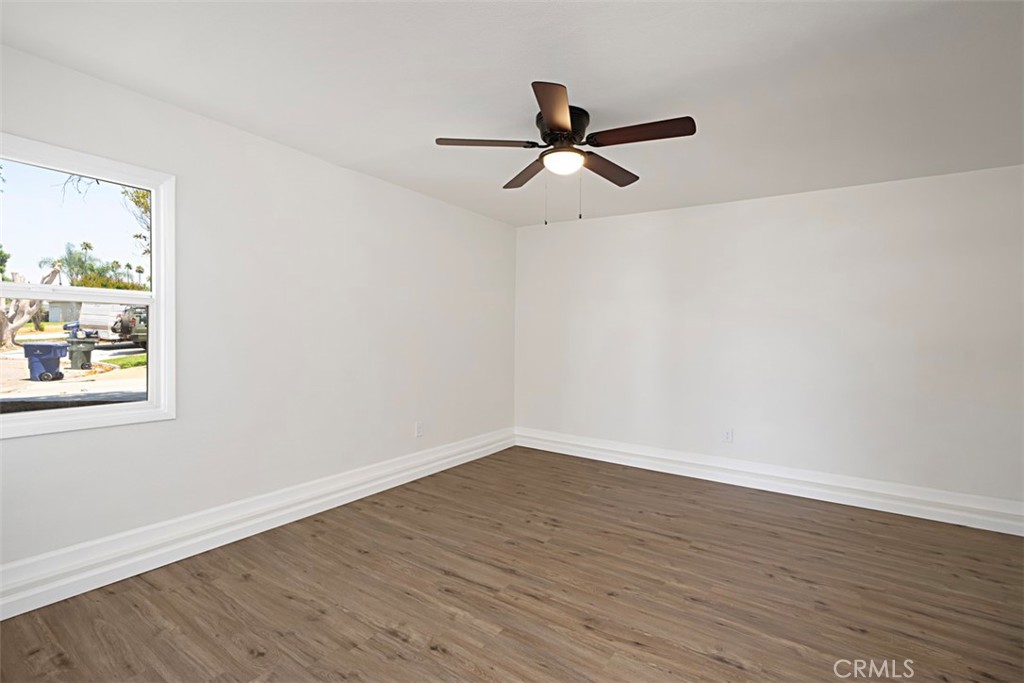 6056 Colonial Drive Riverside, CA 92506 - Photo 19 of 30 a view of a big room with wooden floor and windows