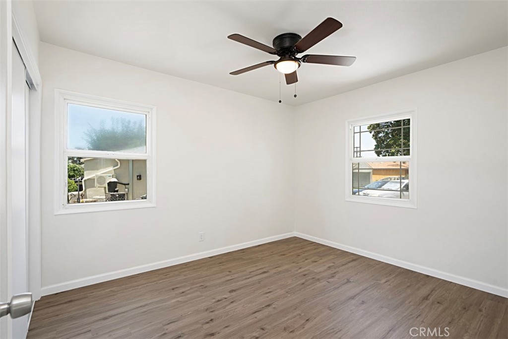 6056 Colonial Drive Riverside, CA 92506 - Photo 23 of 30 a view of an empty room with wooden floor and a window