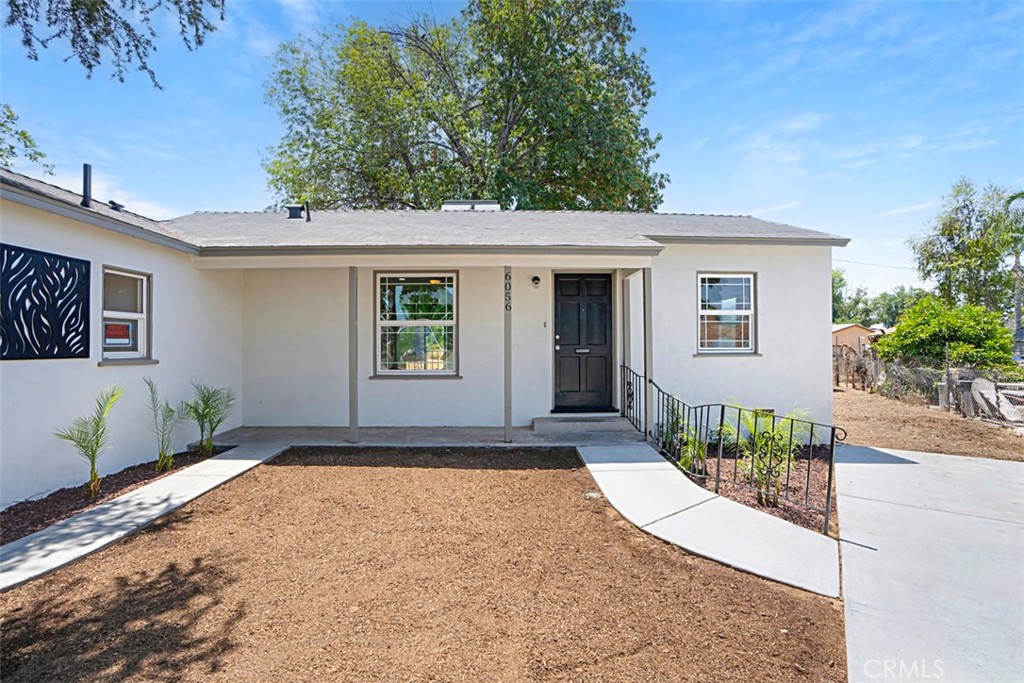 6056 Colonial Drive Riverside, CA 92506 - Photo 5 of 30 a front view of a house with a yard and garage