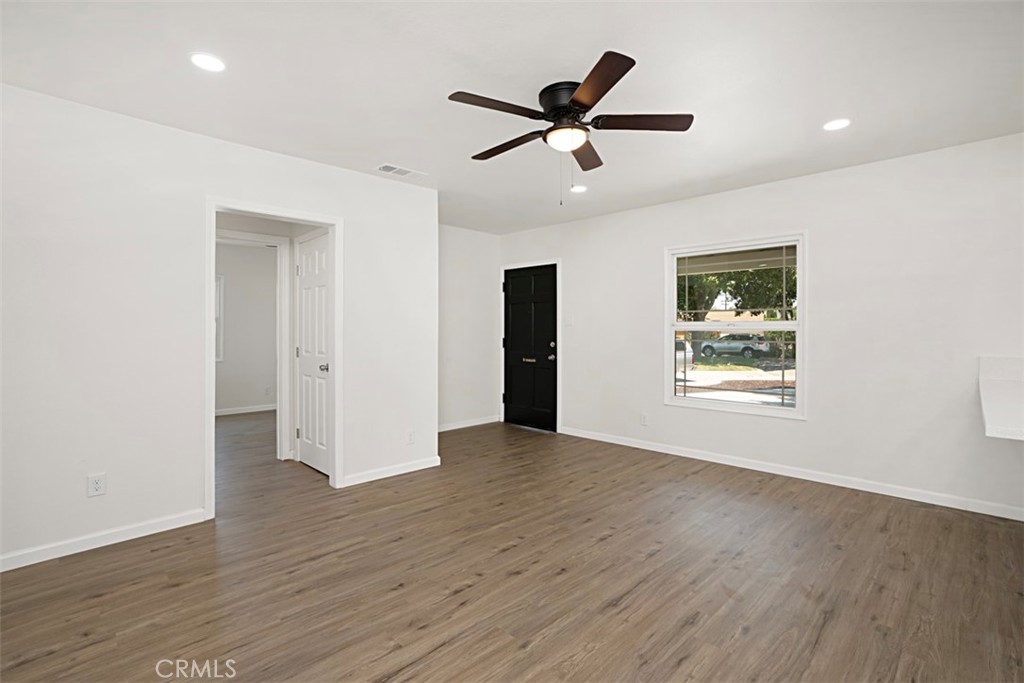 6056 Colonial Drive Riverside, CA 92506 - Photo 9 of 30 a view of a livingroom with a ceiling fan and wooden floor