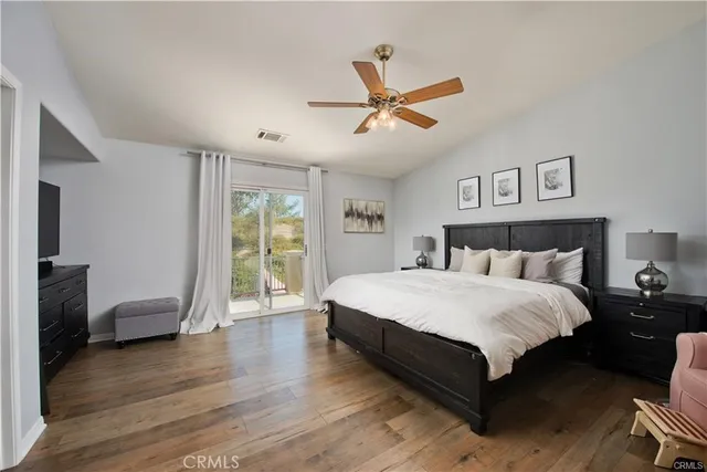 a spacious bedroom with a bed and a window