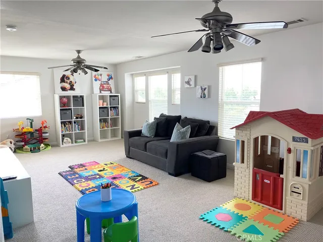 a living room with furniture and a baby crib