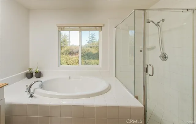 a white bath tub sitting next to a shower