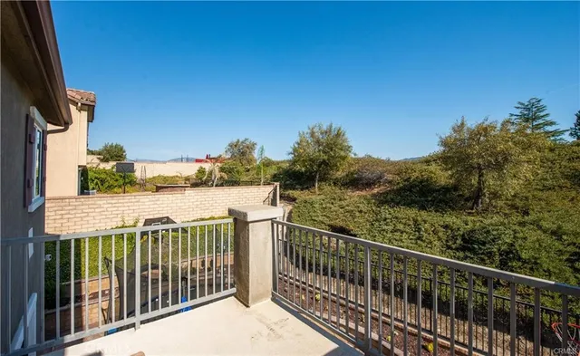 a view of a balcony with wooden fence and floor