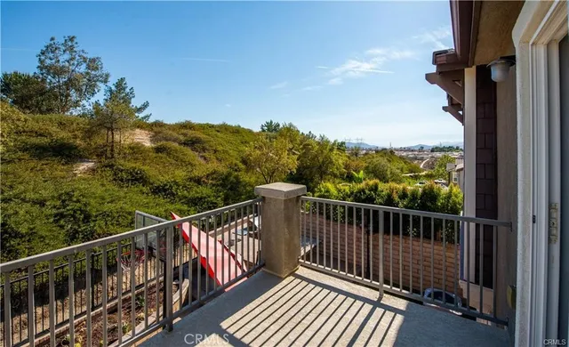 a view of a balcony with wooden floor and fence