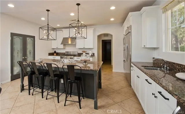 a large kitchen with a table and chairs