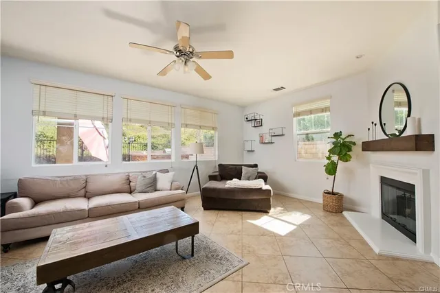 a living room with furniture a window and a fireplace