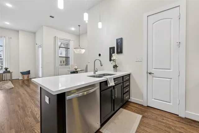 a kitchen with a sink and stainless steel appliances