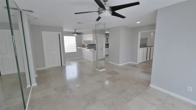a view of a hallway with entryway and kitchen view