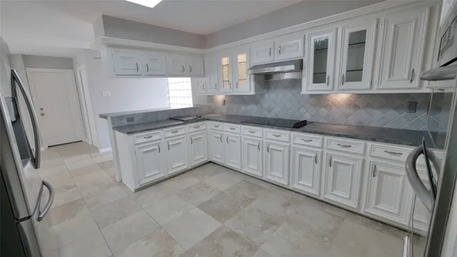 a view of a livingroom with a kitchen