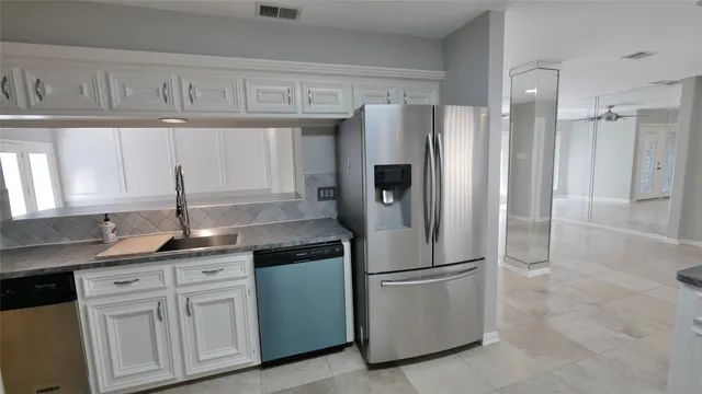 a bathroom with a granite countertop sink a mirror and a shower