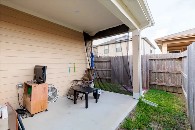 a view of a patio with a table and chairs