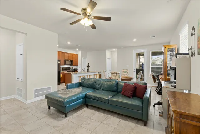 a living room with furniture and kitchen view