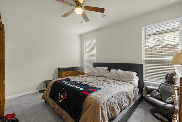 a bedroom with a bed and ceiling fan