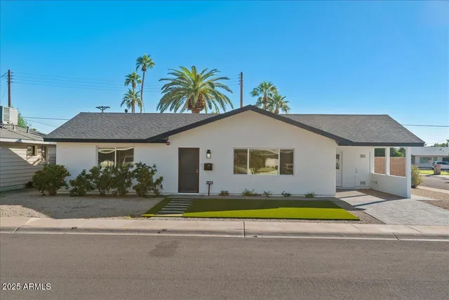a view of a house with pool and a yard