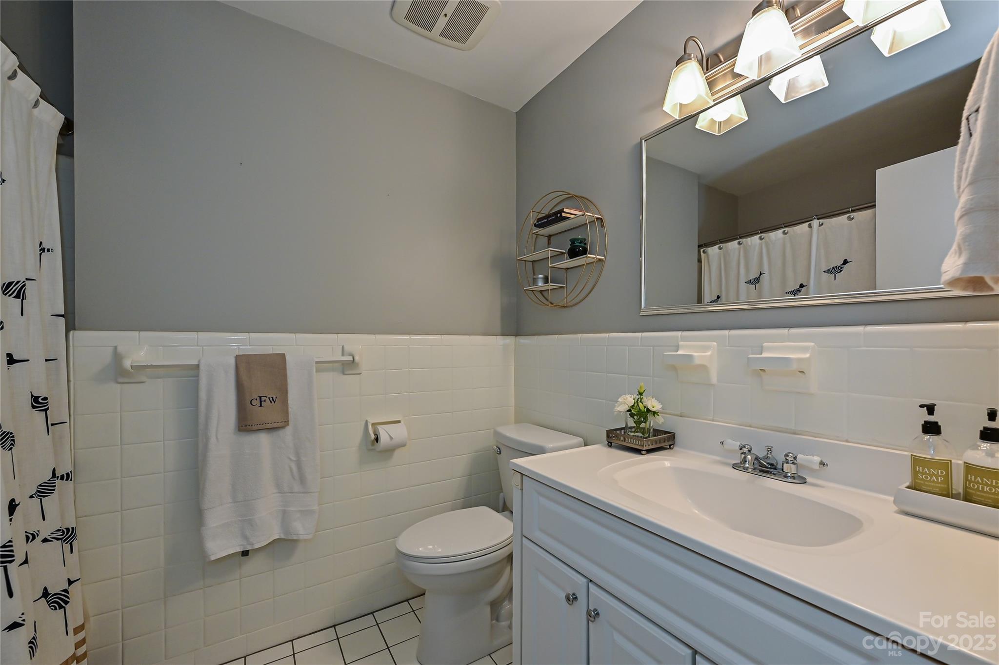 5511 Valley Forge Road Charlotte, NC 28210 - Photo 16 of 22 a bathroom with a sink a toilet and a mirror