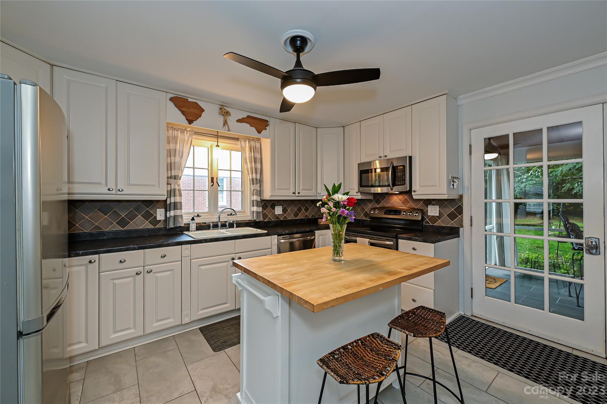 5511 Valley Forge Road Charlotte, NC 28210 - Photo 7 of 22 a kitchen with granite countertop a stove a sink a dining table and chairs