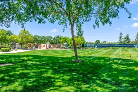 a view of a house with backyard and a patio
